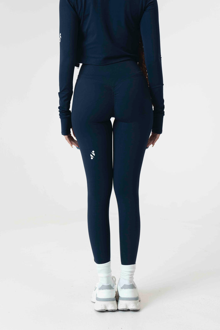 Model wearing S+S high-waist leggings in Midnight Blue, size small, showcasing the sculpting fit and glute-shaping seams.