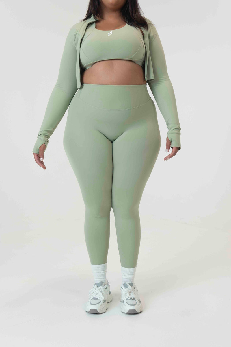 Model wearing S+S high-waist leggings in Sage, size extra large, showcasing the sculpting fit and glute-shaping seams.